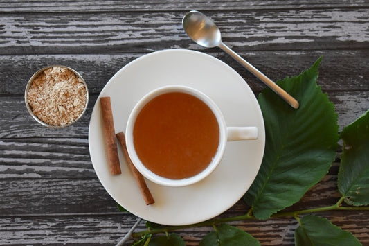 Slippery Elm tea on wood background with slippery elm leaves and powder