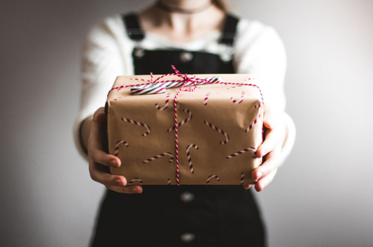 Woman holding kraft wrapped present