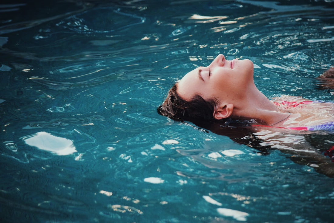 Woman floating in a pool of water