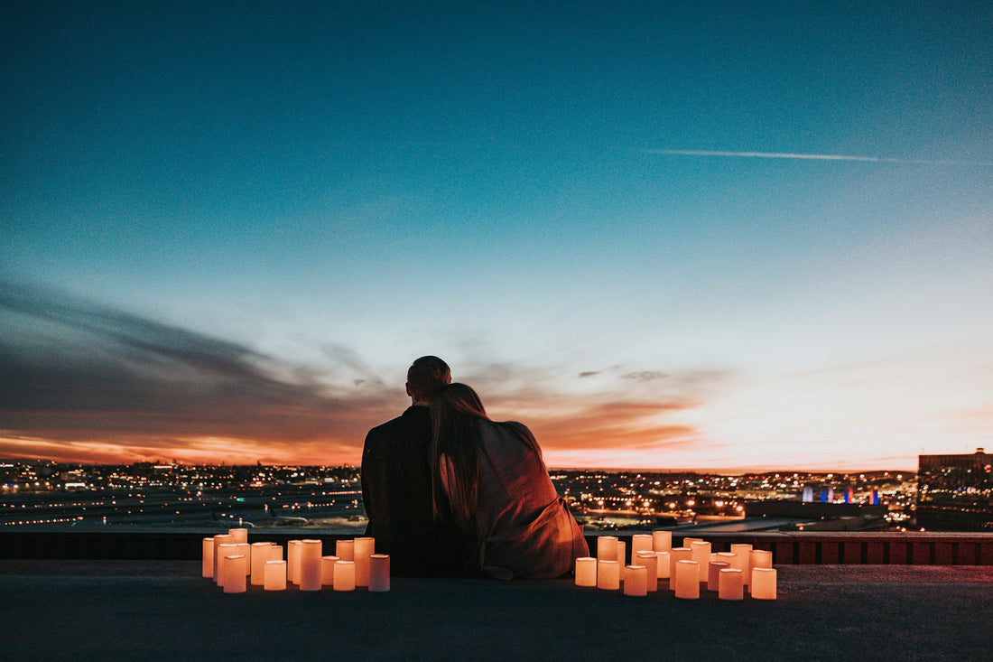 Couple watching the sunset surrounded by candles