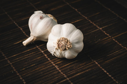 Garlic bulbs on a wooden mat