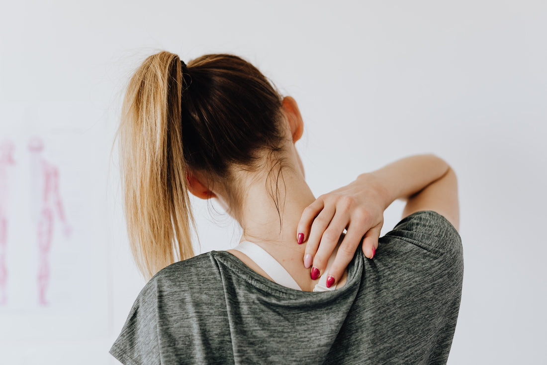 Woman rubbing her neck and upper back