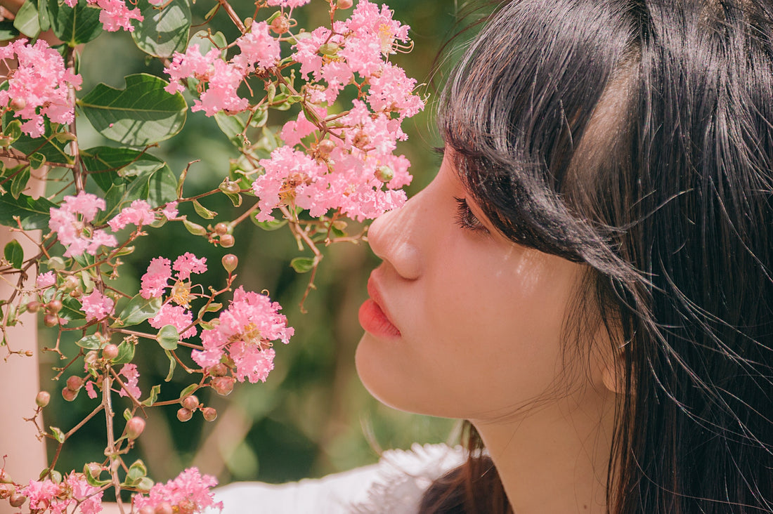 Woman smelling spring flowers