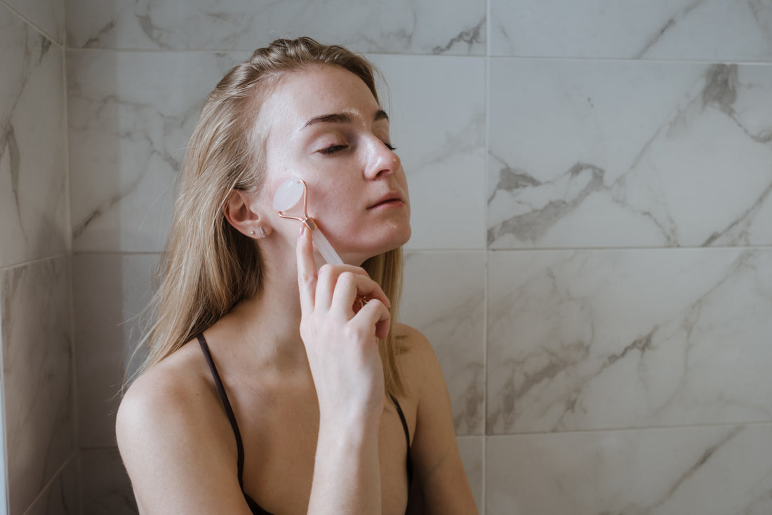 Woman using facial massage roller