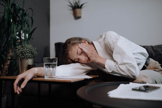 Woman with a headache resting on a table