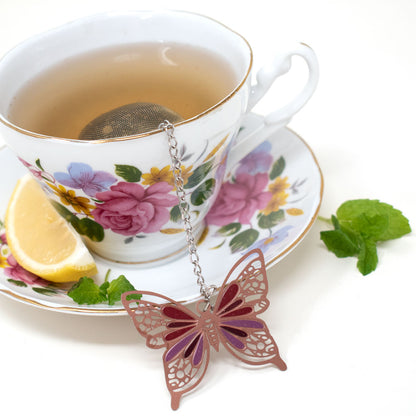 Tea ball with butterfly weight in a tea cup