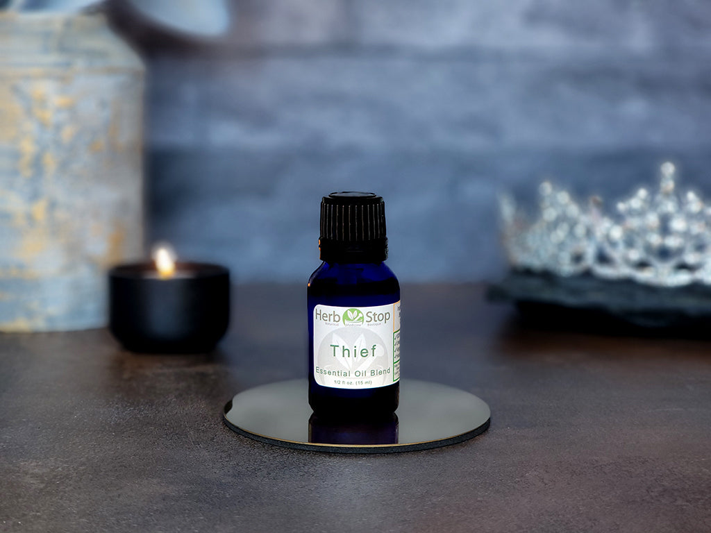 Thief Essential Oil Blend surrounded by jewels and candles